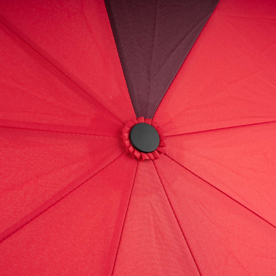 Roka Waterloo recycled polyester umbrella in cranberry and plum colors, close-up of canopy with black button detail.