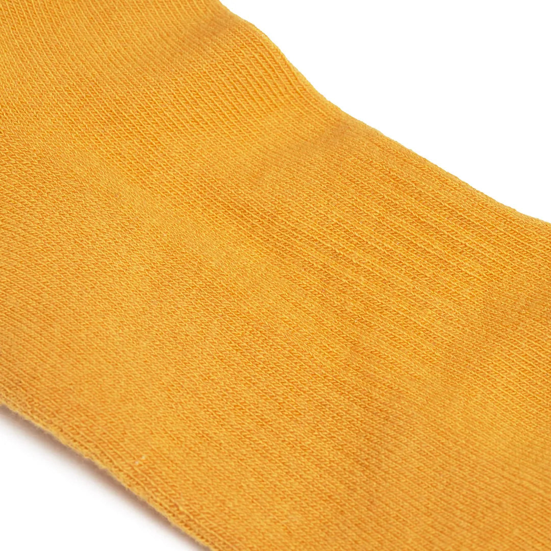 Roka Wembley Corn Organic Cotton One Size sock in vibrant orange, with a seamless knit design and lightweight texture.