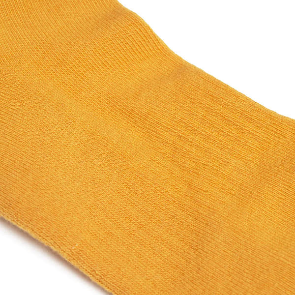 Roka Wembley Corn Organic Cotton One Size sock in vibrant orange, with a seamless knit design and lightweight texture.