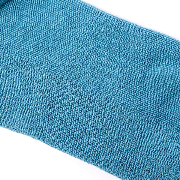 Blue Roka Wembley Cotton Socks in Adriatic color theme, close-up of textured knit fabric.