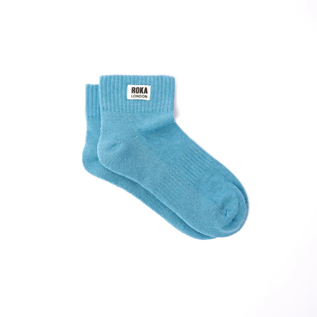 Light blue Roka Wembley cotton ankle socks with a white label featuring black 