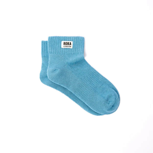 Light blue Roka Wembley cotton ankle socks with a white label featuring black "Roka London" text.