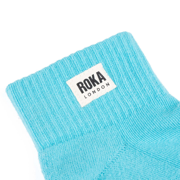Roka Wembley Cotton Socks in Aquatic Awe blue with white logo, breathable, comfortable athletic sock for casual or sports wear.