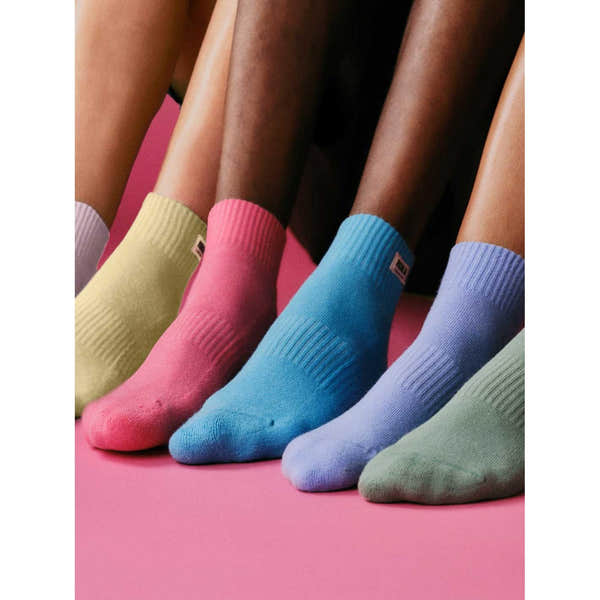 Roka Wembley Cotton Socks in pastel colors with ribbed texture, displayed on a pink background.