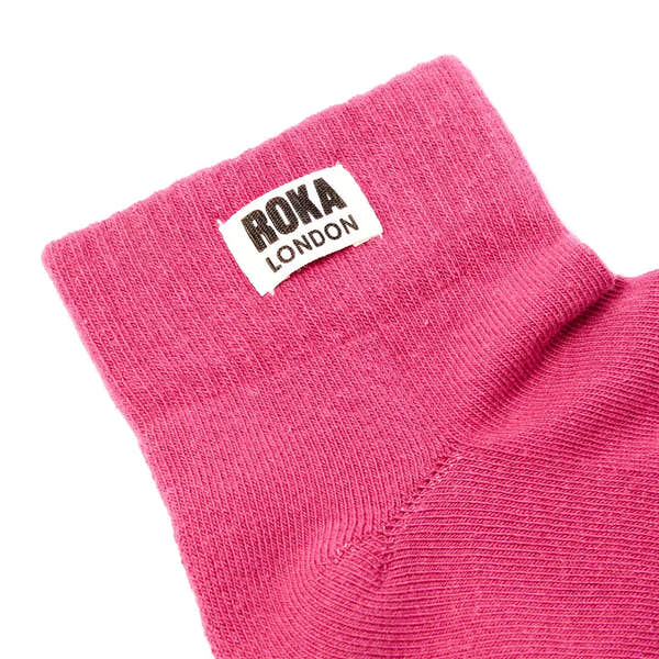 Roka Wembley Cotton Socks in Granita Red, close-up view showing knit fabric and logo label.