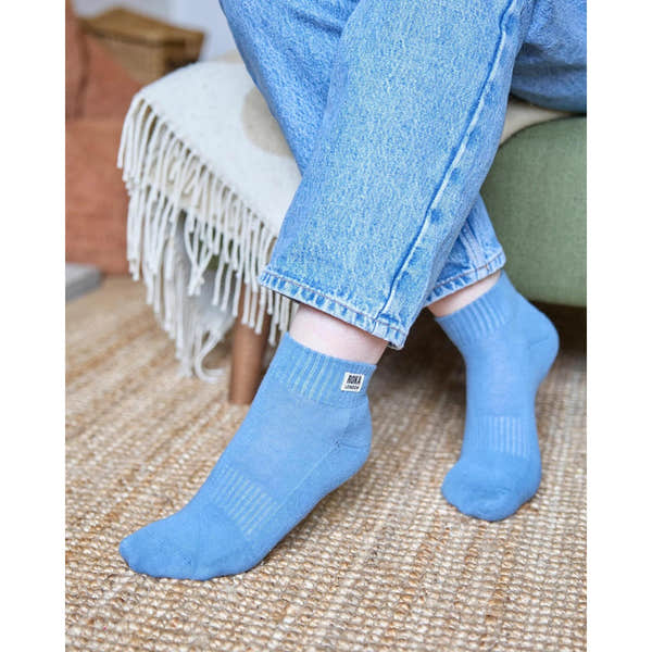 Roka Wembley Ladies Organic Cotton ankle socks in light blue with ribbed cuff, featuring a "Roka London" label.