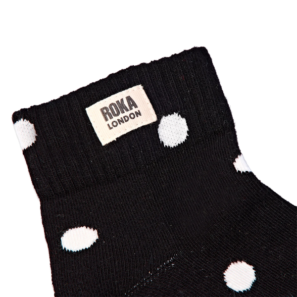 Roka Wembley Ankle Socks for Women in Black Dot — ribbed cuff and logo close-up.