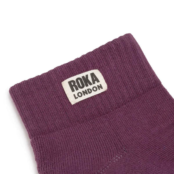 Roka Wembley Ladies Cotton Socks in Berry, featuring a close-up of the purple ankle sock with ROKA London label.