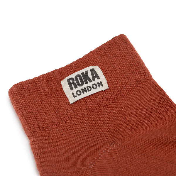 Roka London women's cotton ankle socks in rust color with black logo label, breathable and comfortable for everyday wear.