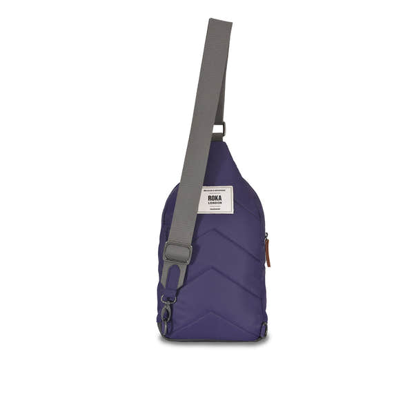 Roka Willesden B Mulberry large recycled nylon sling bag with adjustable grey strap and front zipper pocket.