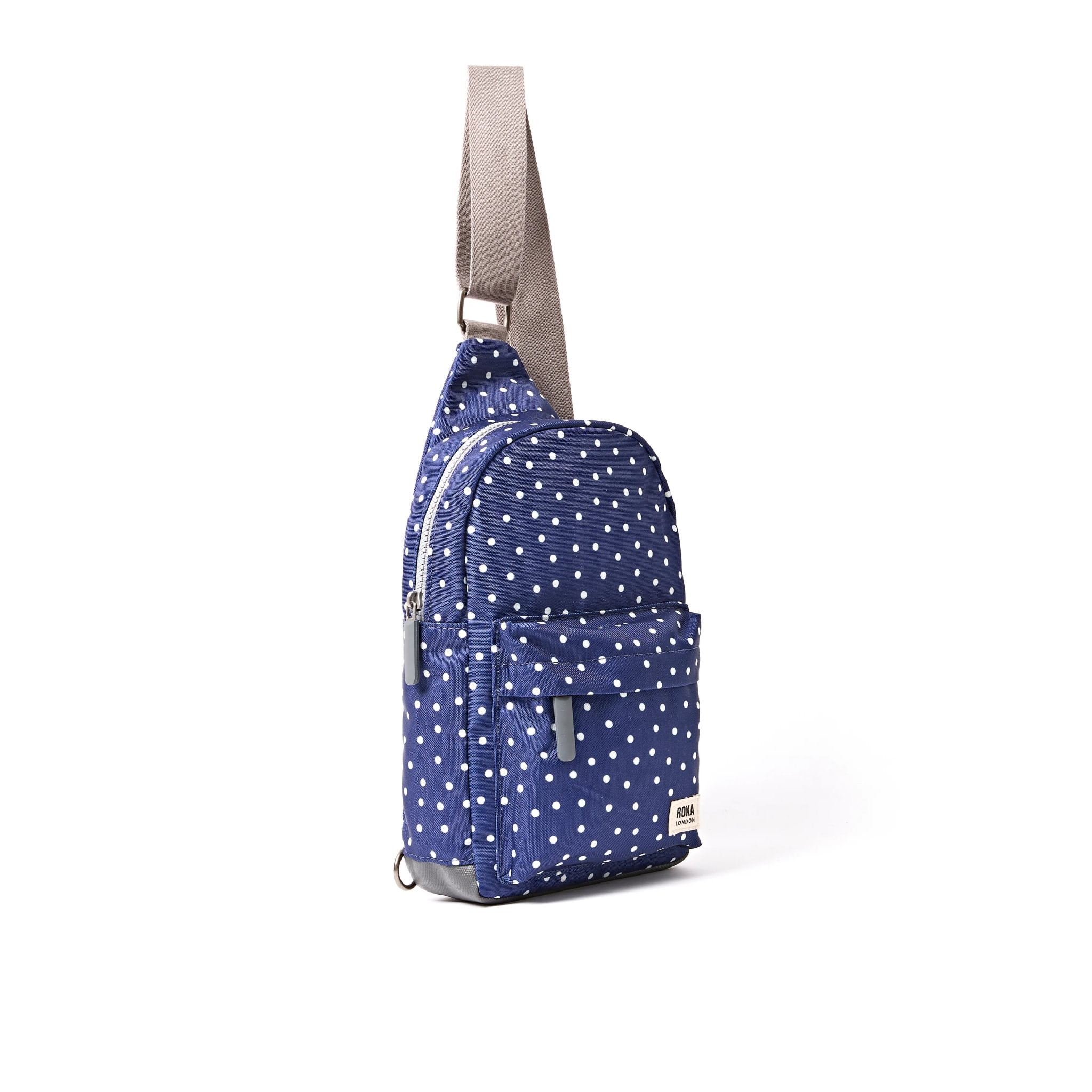 Roka Willesden Navy Polka Dot Recycled Canvas Sling Bag, side view.