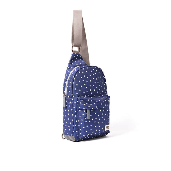 Roka Willesden Navy Polka Dot Recycled Canvas Sling Bag, side view.