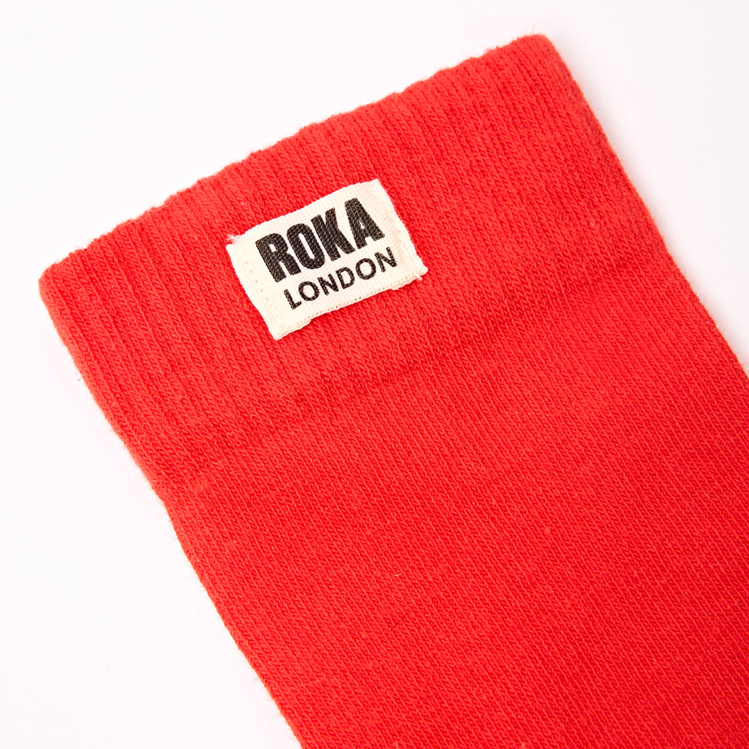 Roka Wimbledon Ladies Cotton Crew Sock in cranberry color, one size, with ROKA London label, made of breathable cotton fabric.