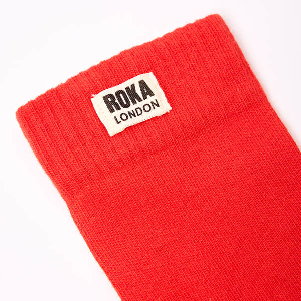 Roka Wimbledon Ladies Cotton Crew Sock in cranberry color, one size, with ROKA London label, made of breathable cotton fabric.