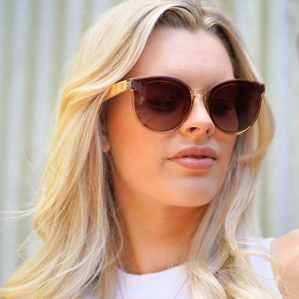SOEK Bella Champagne Brown Gradient Lens sunglasses with Maple arms, stylish oversized frame, on a woman outdoors.