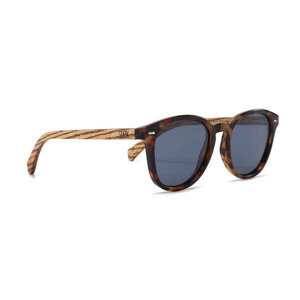 Soek Taine sunglasses with tortoiseshell frame, walnut wood arms, and blue polarized lenses.
