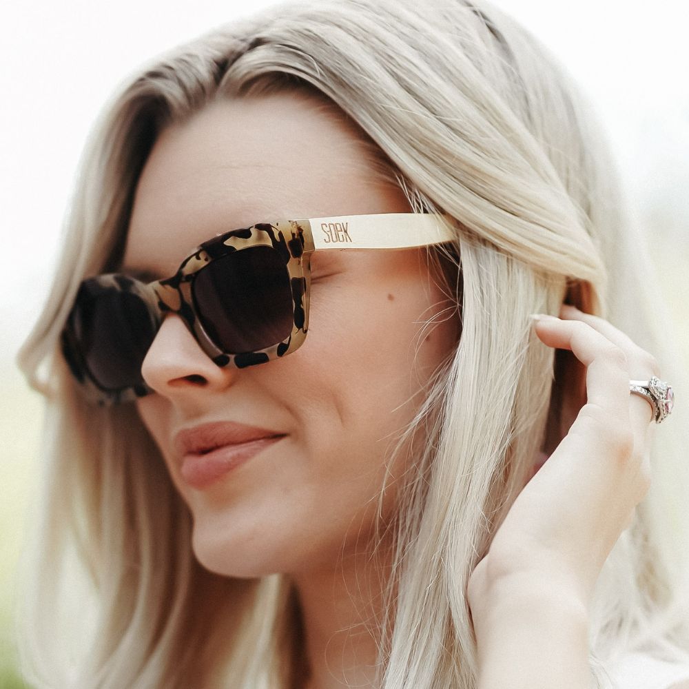 SOEK Zahra Opal Tortoise Magnifying Sunglasses with Reader, stylish leopard print frame, gold arms, and tinted lenses.