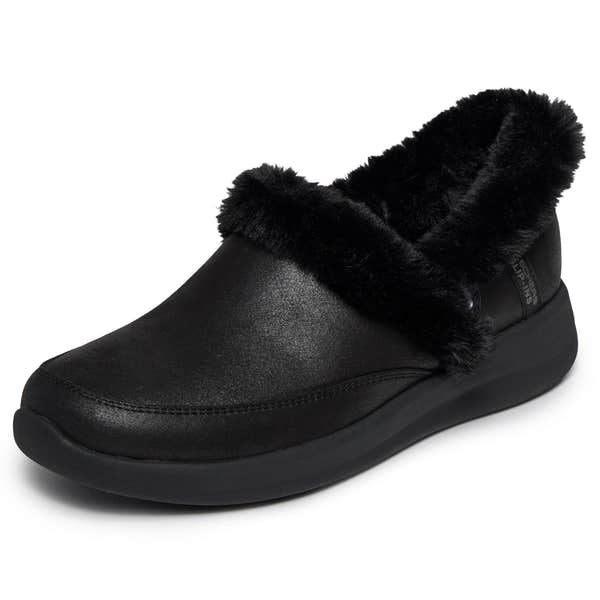 Skechers Cozy Escape slip-on ladies water-resistant vegan leather slippers with plush black faux fur lining.