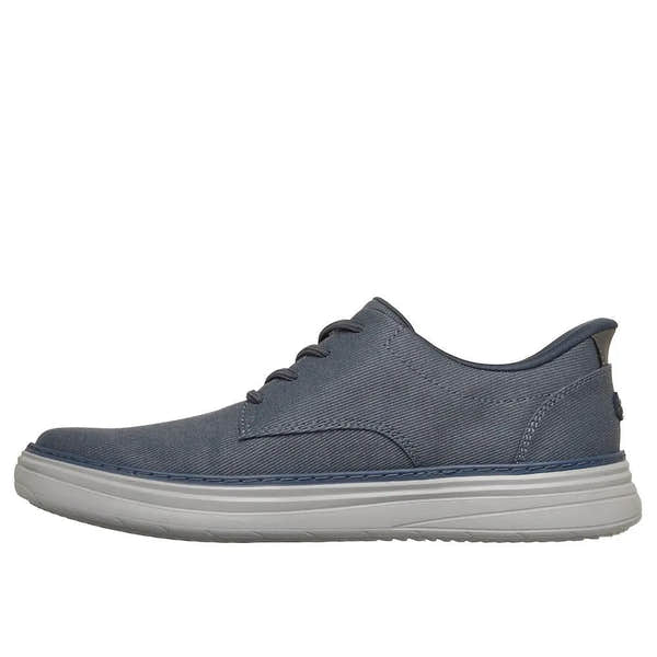 Skechers Hyland-Justino men's navy vegan slip-on trainers with breathable fabric upper and cushioned white sole.