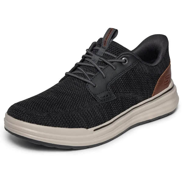 Skechers men's black vegan slip-on trainers, mesh upper, cushioned white sole, casual athletic style.