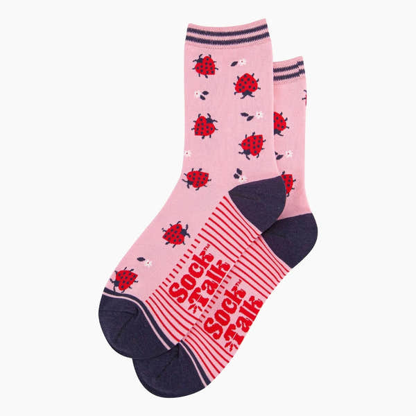 Pink bamboo socks with red ladybird pattern, black toe and heel, striped cuff, and "Sock Talk" branding.