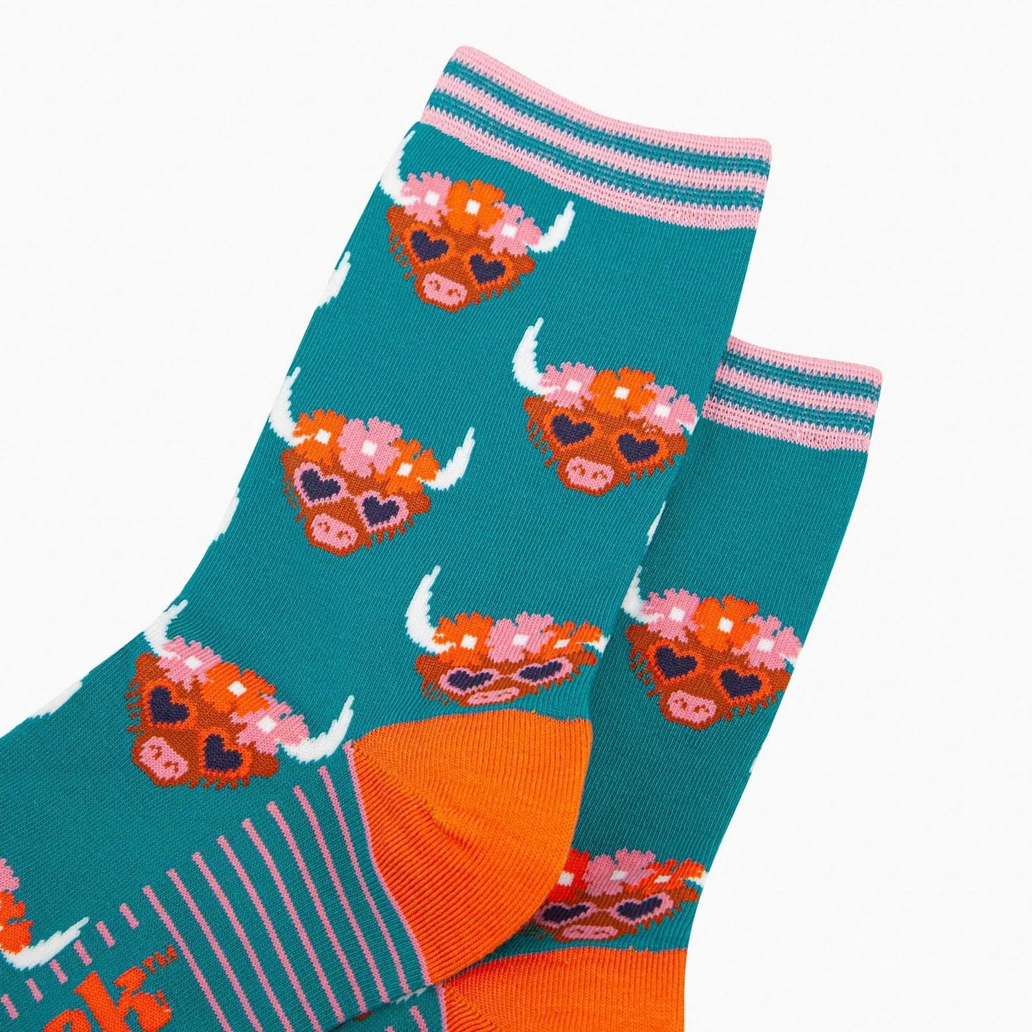 Teal bamboo socks featuring Highland cow with floral crown and heart-shaped sunglasses, striped pink accents, and orange heel detail.