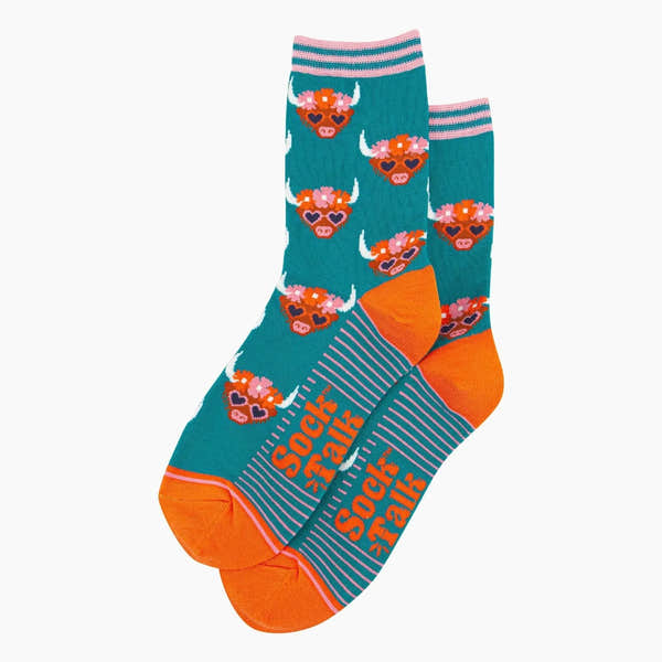 Sock Talk bamboo socks in teal with Highland cow and floral crown pattern, orange toe, and pink striped cuff.