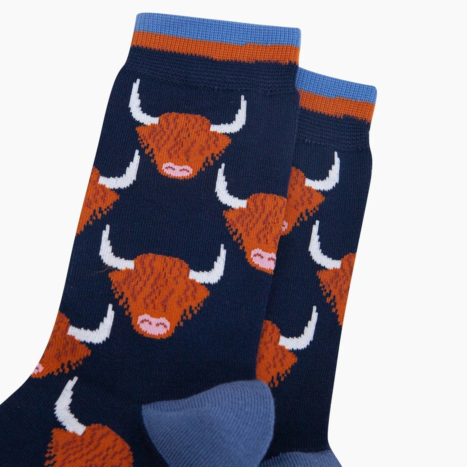 Sock Talk Highland Cow bamboo socks in navy blue with orange and white Highland cow print design.