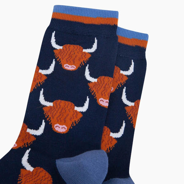 Sock Talk Highland Cow bamboo socks in navy blue with orange and white Highland cow print design.