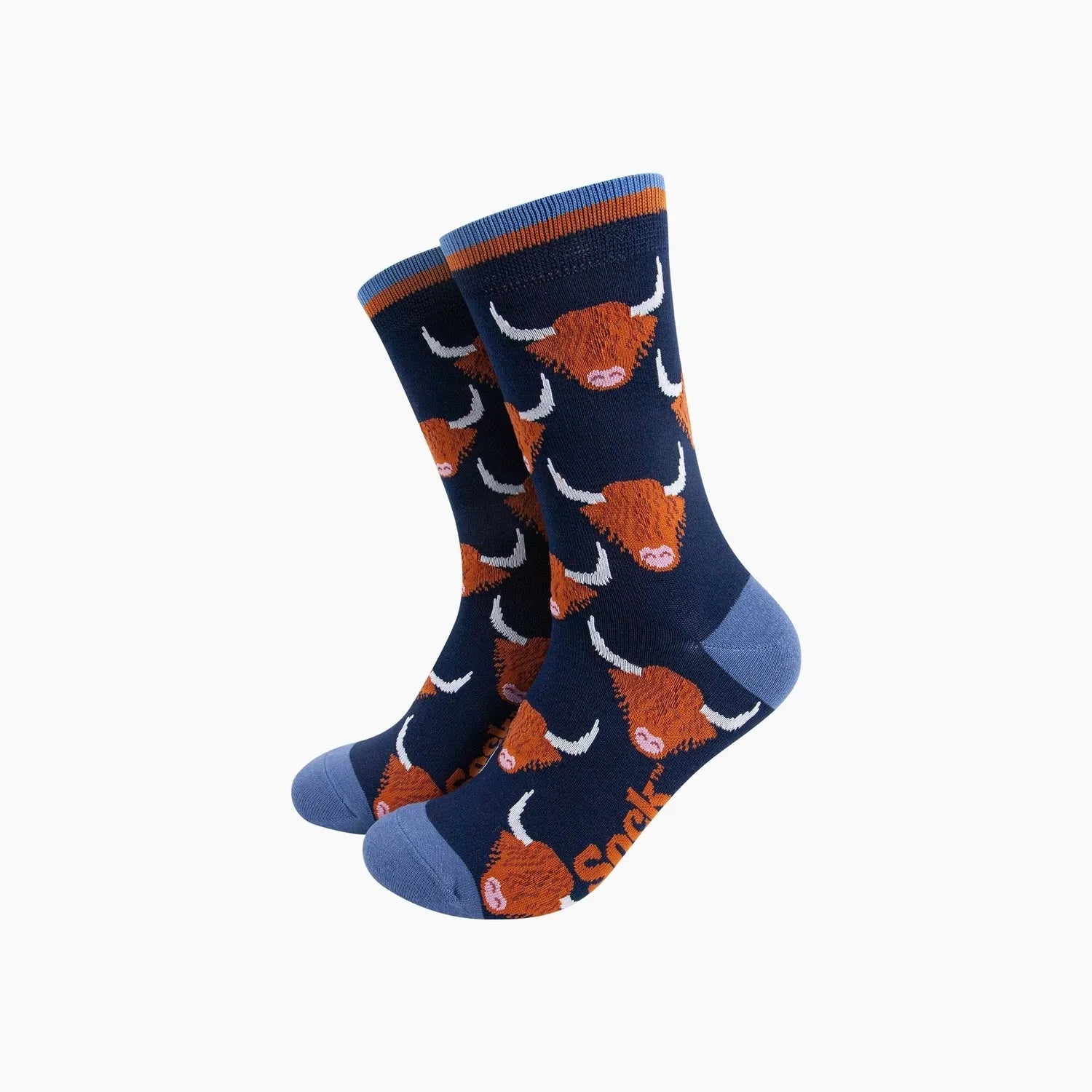 Sock Talk Highland Cow bamboo socks in navy blue with orange Highland Cow pattern, blue toe and heel, and striped cuff.