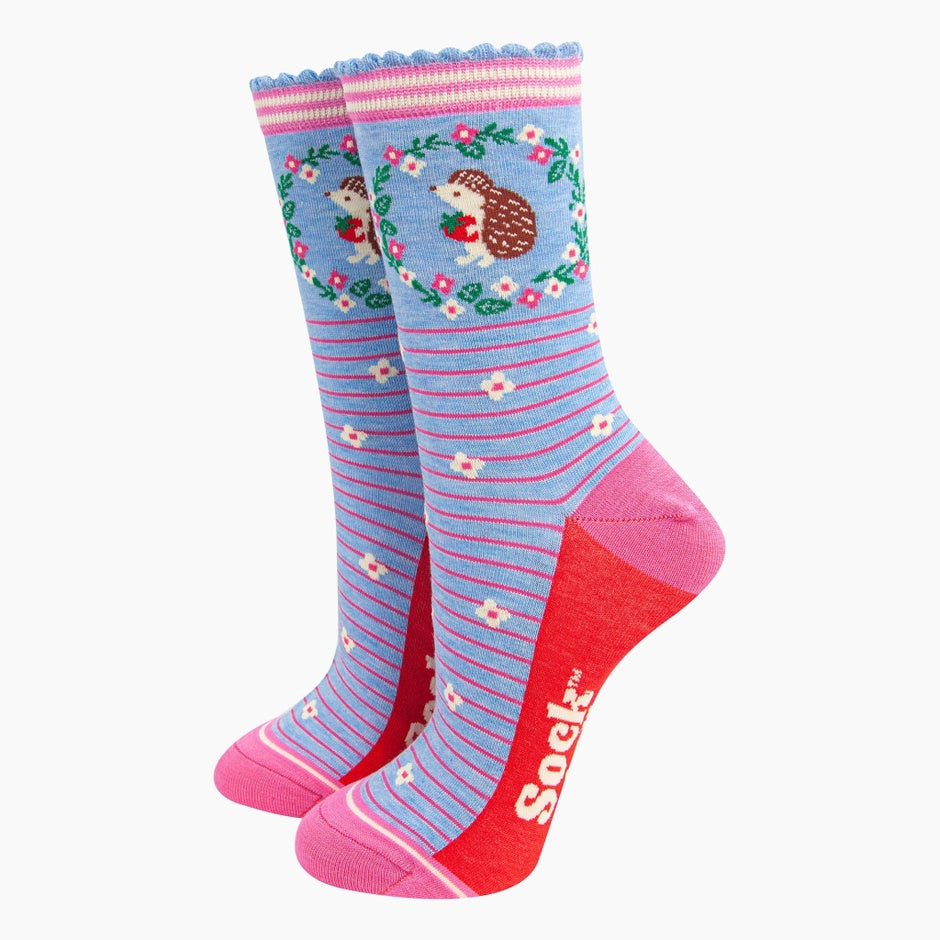 Sock Talk ladies blue hedgehog wreath and strawberry bamboo socks, with pink heels, toes, and cuff, featuring playful floral and stripe patterns.
