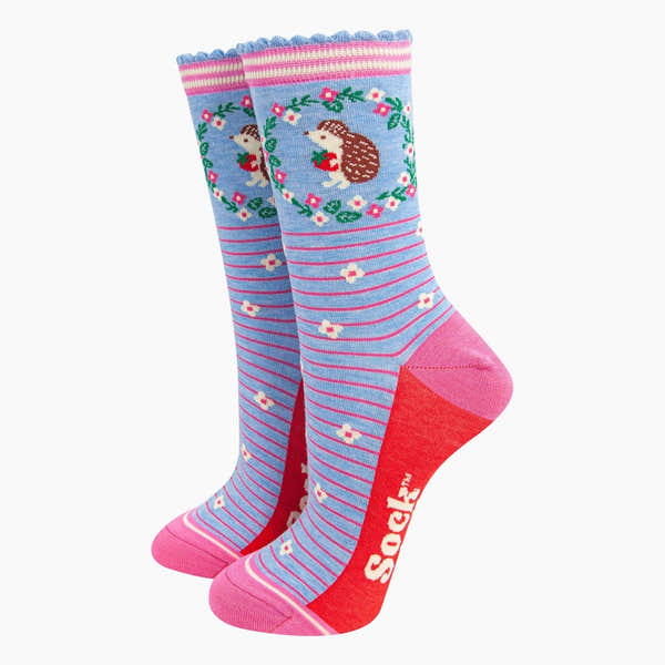 Sock Talk ladies blue hedgehog wreath and strawberry bamboo socks, with pink heels, toes, and cuff, featuring playful floral and stripe patterns.