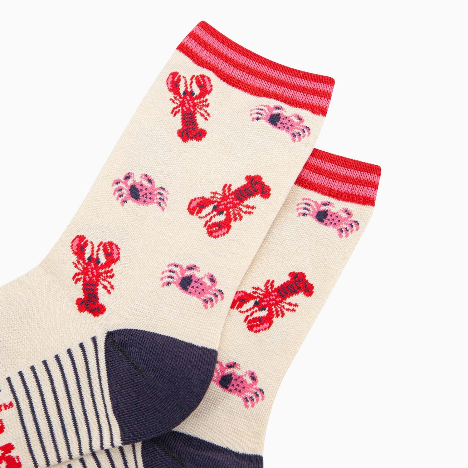 Ladies cream bamboo socks with lobster and crab designs, red and pink striped cuffs, navy toe, and heel.