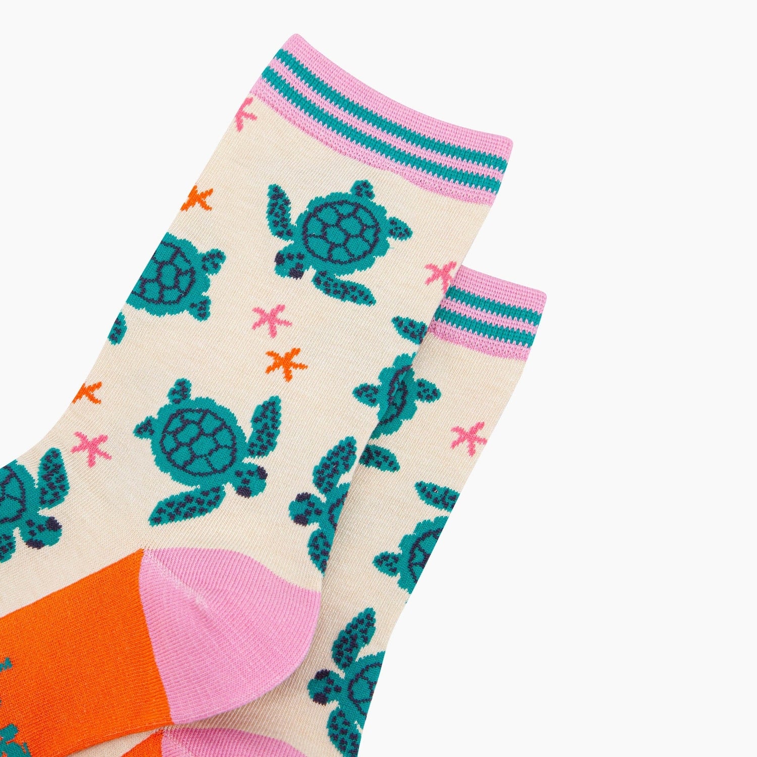 Women's cream bamboo socks featuring sea turtles and starfish, with pink, teal, and orange accents.