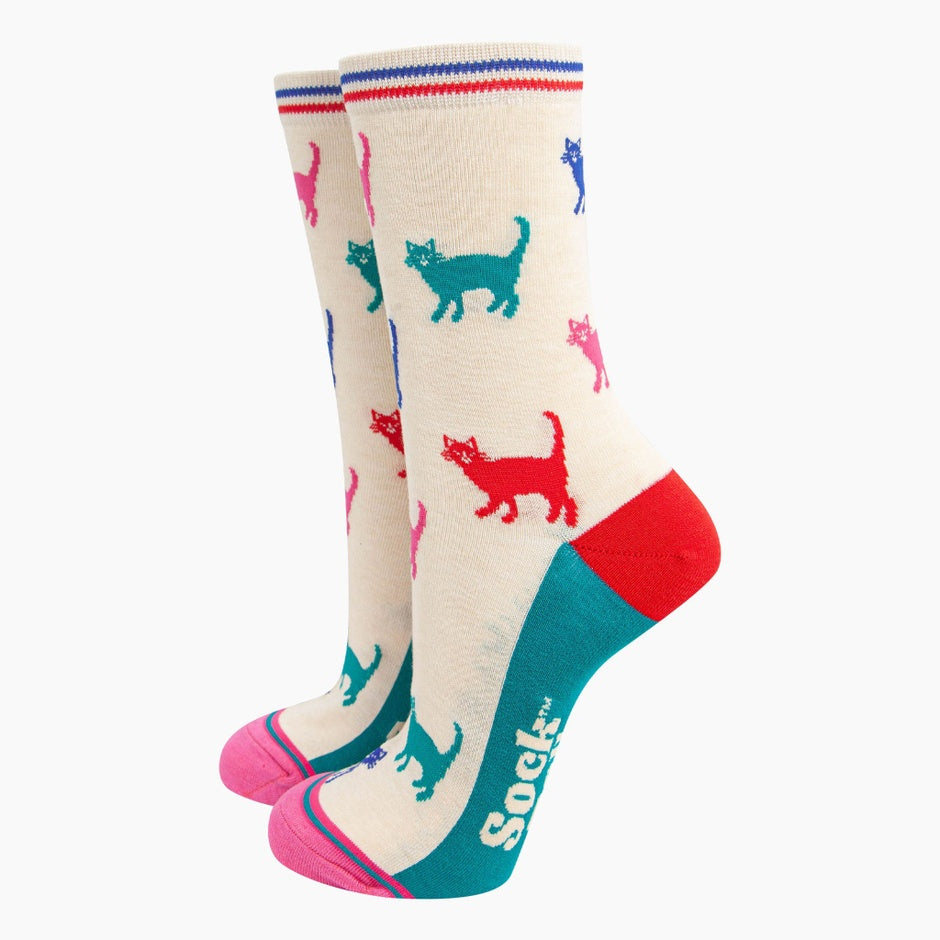 Sock Talk Ladies cream/multi cats bamboo socks with colorful cat pattern, red heel, turquoise toe, and striped band at top.