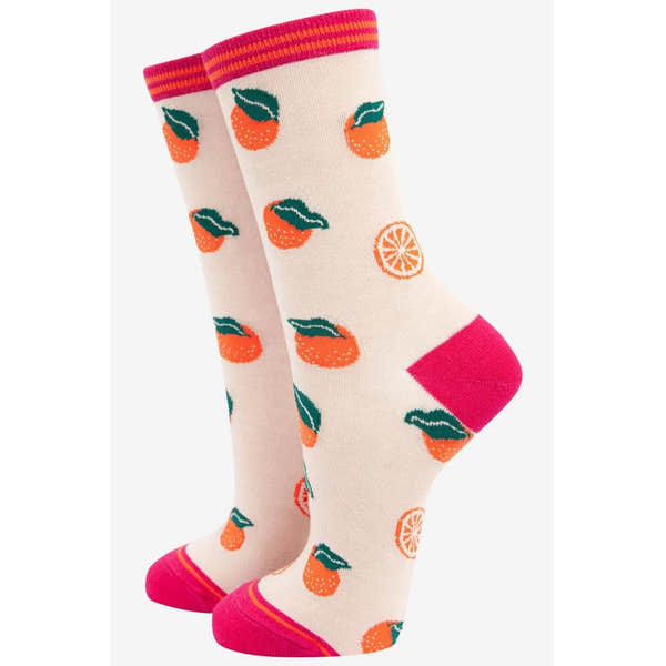 Ladies orange fruit bamboo socks with a fun citrus pattern, pink toe and heel, and striped trim at the top.