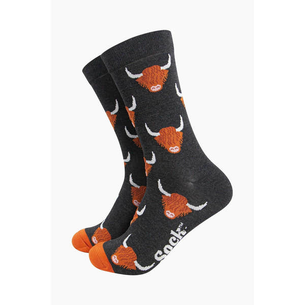 Men's black bamboo socks with Highland cow pattern, featuring orange toes and white detail, by Sock Talk.