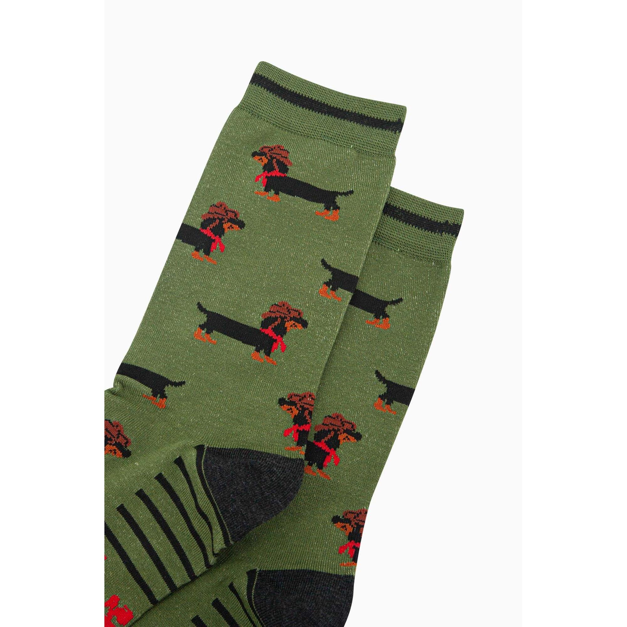 Men's green bamboo socks featuring a Sausage Dog cowboy design with black and orange accents.