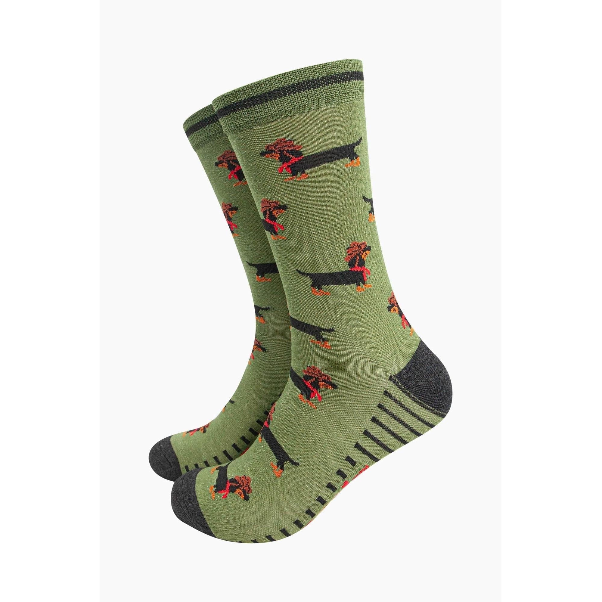 Green bamboo men's socks with dachshund and sausage dog pattern, featuring a cowboy motif, black toe and heel, and stripe details.