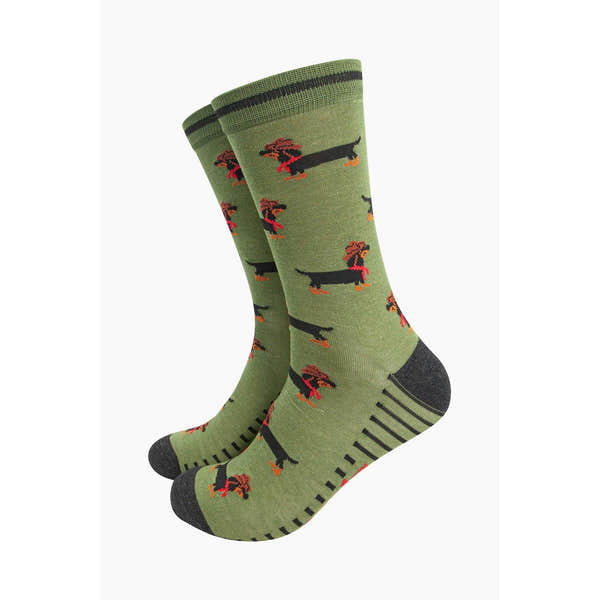 Green bamboo men's socks with dachshund and sausage dog pattern, featuring a cowboy motif, black toe and heel, and stripe details.