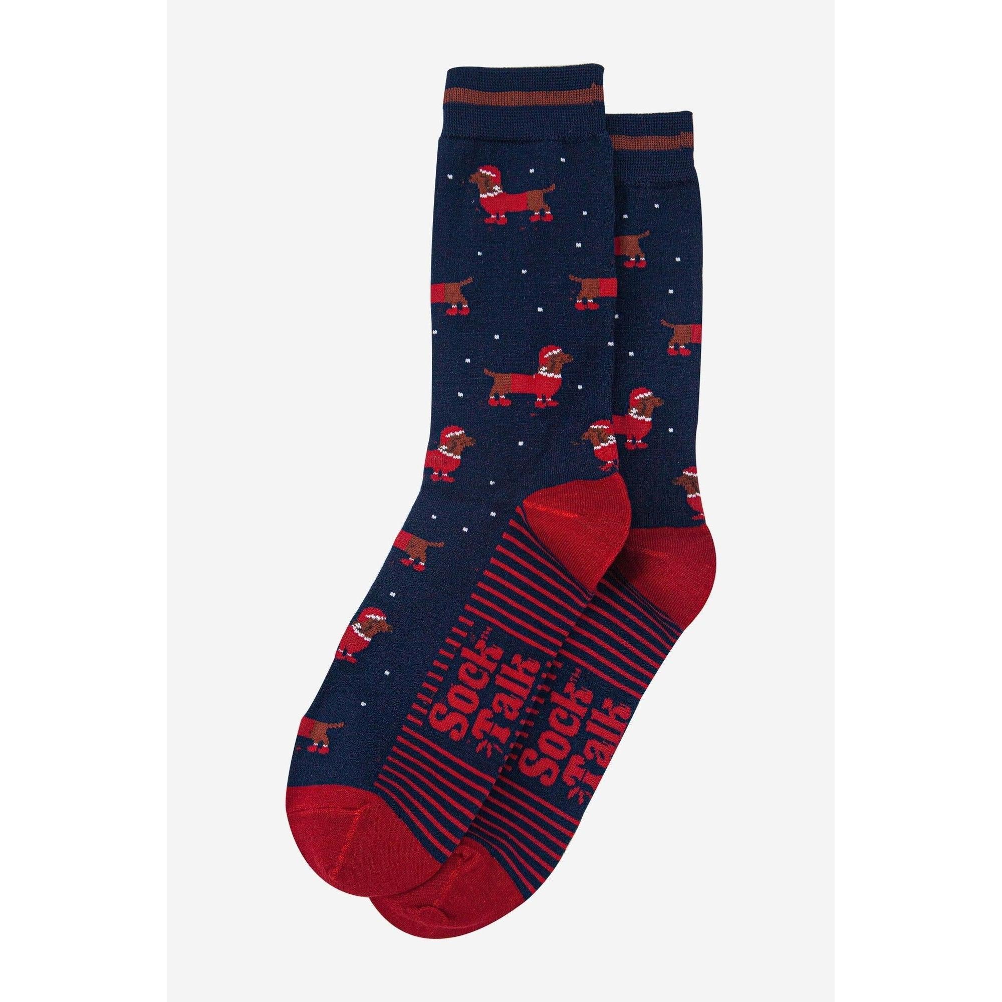 Sock Talk men's navy blue bamboo socks with red Santa sausage dog pattern and striped text design.
