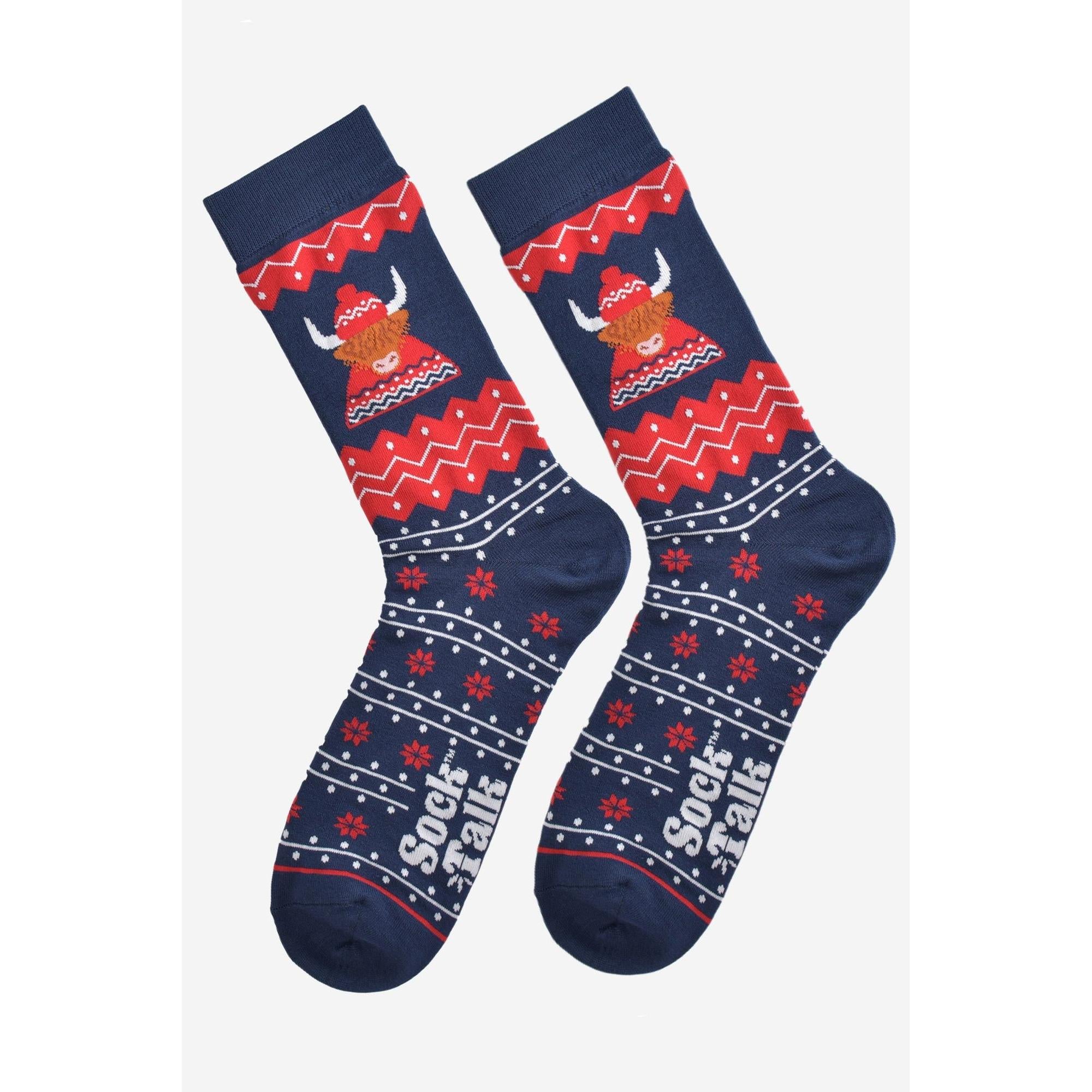 Men's navy and red bamboo socks with Highland cow, hat, jumper design, and festive snowflake pattern.