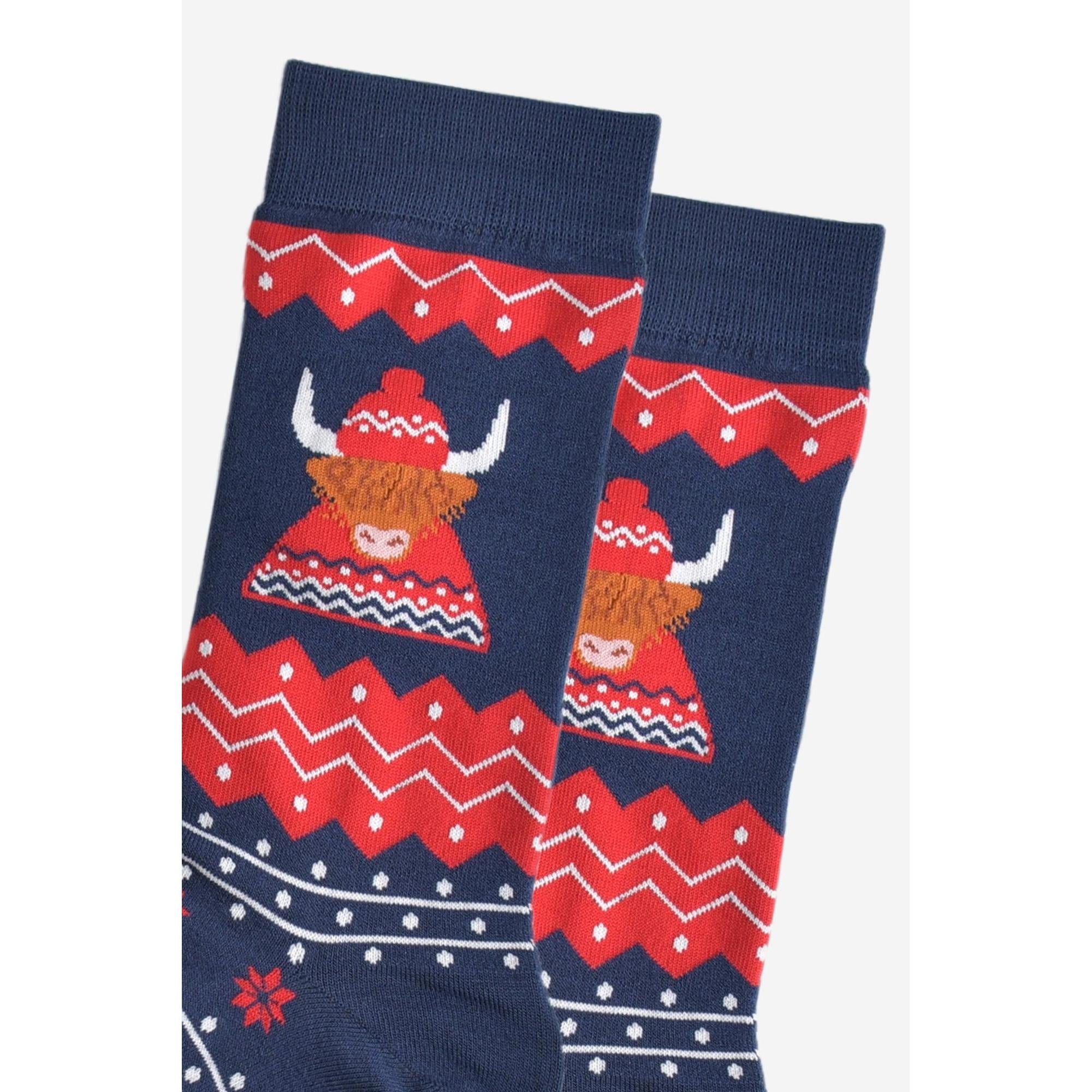 Sock Talk men's bamboo socks with a red, navy, and white Highland Cow, hat, and jumper design, festive pattern, mid-calf length.