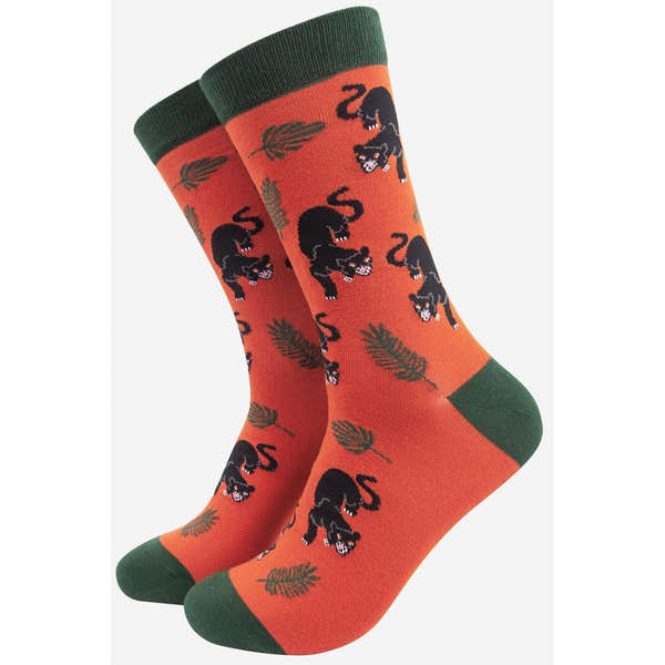Sock Talk men's black panther jungle leaf print bamboo socks with orange and green accents.