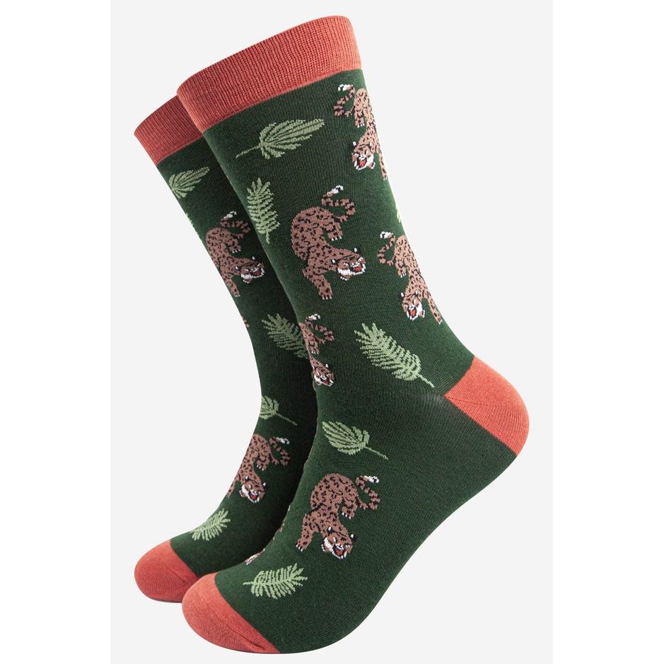 Sock Talk men's bamboo socks featuring a prowling cheetah and jungle leaf print, in green with coral accents.