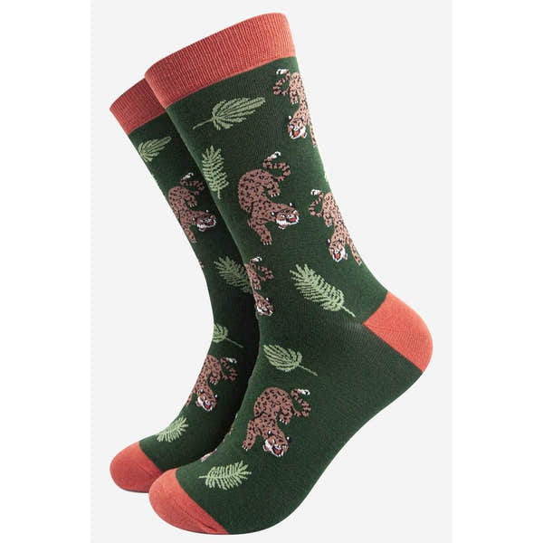 Sock Talk men's bamboo socks featuring a prowling cheetah and jungle leaf print, in green with coral accents.