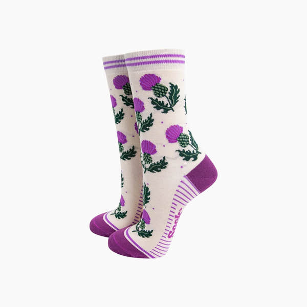 Sock Talk Scottish Thistles bamboo socks in cream with purple thistle pattern, purple heels, toes, and striped cuffs.