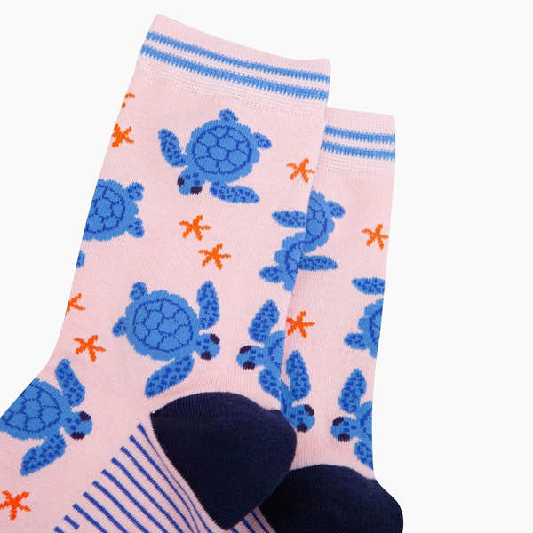 Sock Talk Sea Turtles pink bamboo socks with blue turtle and orange starfish pattern, reinforced toe and striped cuff.