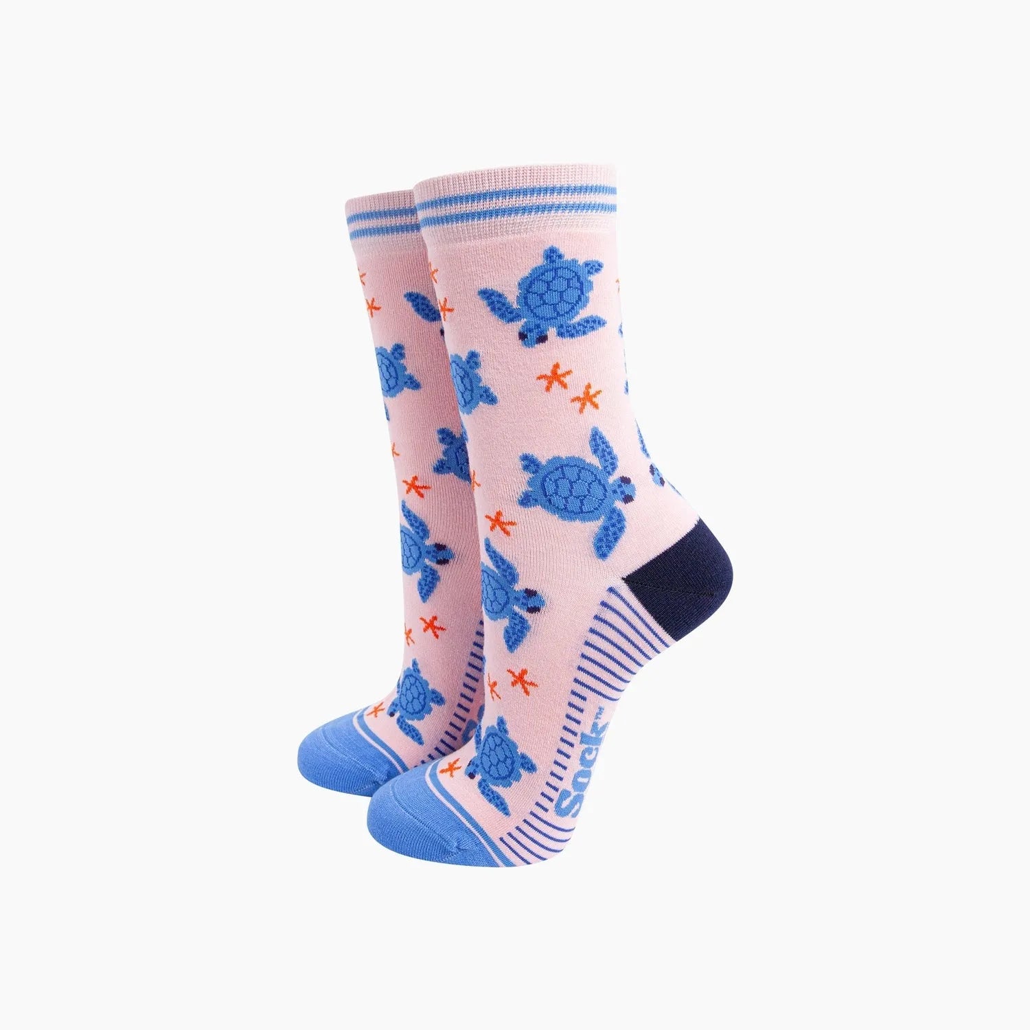 Sock Talk Sea Turtles pink bamboo socks with blue turtle and starfish patterns, blue toe and heel, and striped cuffs.
