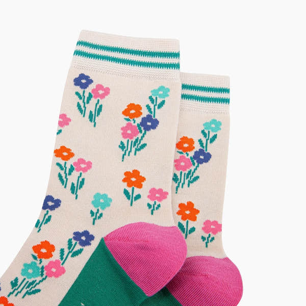 Sock Talk Wildflowers Bamboo Socks in Cream with colorful floral pattern, green toe, pink heel, and striped cuff.